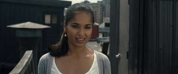 Movie still from “30 Minutes or Less” (2011), directed by Ruben Fleischer – A beautiful young lady smiling for the camera; Close Up shot, Over the shoulder angle