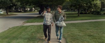 Movie still from “30 Minutes or Less” (2011), directed by Ruben Fleischer – Two young men walking down a sidewalk holding hands; Medium shot, Over the shoulder angle