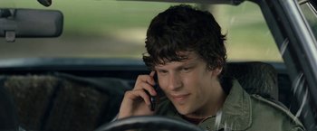 Movie still from “30 Minutes or Less” (2011), directed by Ruben Fleischer – A man sitting in a car talking on a cell phone; Close Up shot, Over the shoulder angle