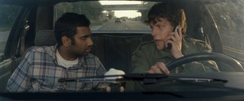 Movie still from “30 Minutes or Less” (2011), directed by Ruben Fleischer – Two men sitting in the back seat of a car talking; Medium shot, Over the shoulder angle