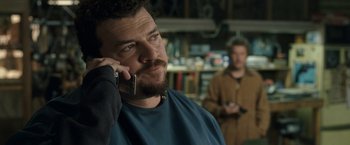 Movie still from “30 Minutes or Less” (2011), directed by Ruben Fleischer – A man talking on a cell phone while another man watches; Close Up shot, Over the shoulder angle