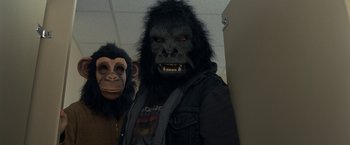Movie still from “30 Minutes or Less” (2011), directed by Ruben Fleischer – Two people wearing gorilla masks in a room; Close Up shot, Low angle
