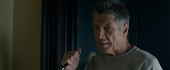 Movie still from “30 Minutes or Less” (2011), directed by Ruben Fleischer – An older man is holding a pen in his hand; Close Up shot, Over the shoulder angle