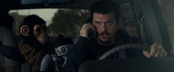 Movie still from “30 Minutes or Less” (2011), directed by Ruben Fleischer – A man talking on a cell phone while sitting in a car; Close Up shot, Over the shoulder angle