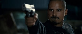 Movie still from “30 Minutes or Less” (2011), directed by Ruben Fleischer – A person holding a gun; Close Up shot, Over the shoulder angle