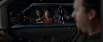 Movie still from “30 Minutes or Less” (2011), directed by Ruben Fleischer – A group of people sitting in a car looking out of the window; Medium shot, Over the shoulder angle