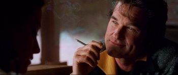 Movie still from “3000 Miles to Graceland” (2001), directed by Demian Lichtenstein – A person smoking a cigarette; Close Up shot, Low angle