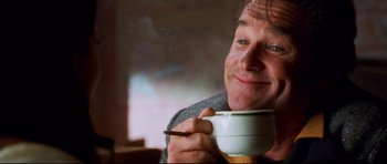 Movie still from “3000 Miles to Graceland” (2001), directed by Demian Lichtenstein – A person holding a cup of coffee; Close Up shot, Low angle