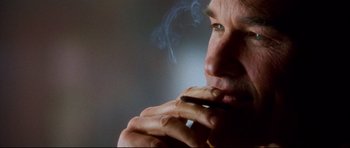 Movie still from “3000 Miles to Graceland” (2001), directed by Demian Lichtenstein – A person smoking a cigarette; Extreme Close Up shot, Low angle