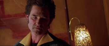 Movie still from “3000 Miles to Graceland” (2001), directed by Demian Lichtenstein – A person wearing a suit and tie; Close Up shot, Low angle