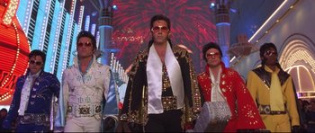 Movie still from “3000 Miles to Graceland” (2001), directed by Demian Lichtenstein – A group of people dressed up as elvis presley; Wide shot, Low angle