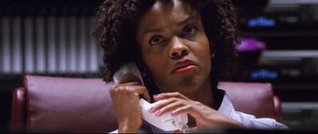 Movie still from “3000 Miles to Graceland” (2001), directed by Demian Lichtenstein – A woman holding a phone up to her ear; Close Up shot, Low angle