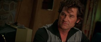 Movie still from “3000 Miles to Graceland” (2001), directed by Demian Lichtenstein – A person wearing a striped shirt; Close Up shot, Over the shoulder angle