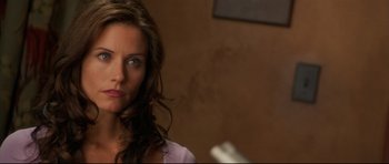 Movie still from “3000 Miles to Graceland” (2001), directed by Demian Lichtenstein – A person with long brown hair; Close Up shot, Over the shoulder angle