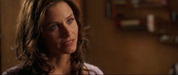 Movie still from “3000 Miles to Graceland” (2001), directed by Demian Lichtenstein – A person with long brown hair; Close Up shot, Over the shoulder angle