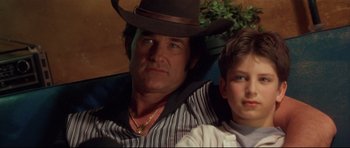 Movie still from “3000 Miles to Graceland” (2001), directed by Demian Lichtenstein – A man and a boy wearing a cowboy hat; Close Up shot, Low angle