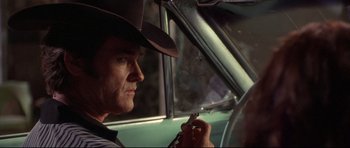 Movie still from “3000 Miles to Graceland” (2001), directed by Demian Lichtenstein – A man in a cowboy hat looking out of a car window; Close Up shot, Over the shoulder angle