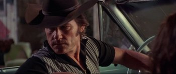 Movie still from “3000 Miles to Graceland” (2001), directed by Demian Lichtenstein – A person wearing a cowboy hat; Close Up shot, Low angle