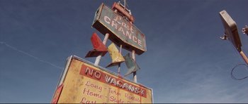 Movie still from “3000 Miles to Graceland” (2001), directed by Demian Lichtenstein – An old neon sign is on top of a pole; Extreme Wide shot, Overhead angle
