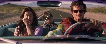 Movie still from “3000 Miles to Graceland” (2001), directed by Demian Lichtenstein – A man and a woman in a car with a boy in the back seat; Medium shot, Over the shoulder angle