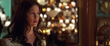 Movie still from “3000 Miles to Graceland” (2001), directed by Demian Lichtenstein – A woman standing in front of a bunch of lights in a room; Close Up shot, Over the shoulder angle