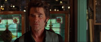 Movie still from “3000 Miles to Graceland” (2001), directed by Demian Lichtenstein – A person wearing a suit and tie; Close Up shot, Over the shoulder angle