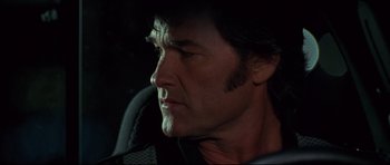 Movie still from “3000 Miles to Graceland” (2001), directed by Demian Lichtenstein – A person wearing a cowboy hat; Close Up shot, Over the shoulder angle