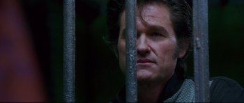Movie still from “3000 Miles to Graceland” (2001), directed by Demian Lichtenstein – A person behind a metal fence; Close Up shot, Low angle