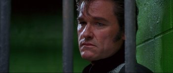 Movie still from “3000 Miles to Graceland” (2001), directed by Demian Lichtenstein – A person wearing a sweater; Close Up shot, Low angle