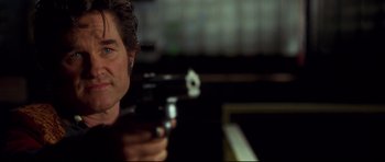 Movie still from “3000 Miles to Graceland” (2001), directed by Demian Lichtenstein – A man is holding a gun in his hand; Close Up shot, Low angle