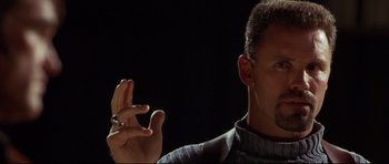 Movie still from “3000 Miles to Graceland” (2001), directed by Demian Lichtenstein – A person holding something in his hand; Close Up shot, Low angle