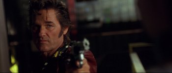 Movie still from “3000 Miles to Graceland” (2001), directed by Demian Lichtenstein – A person holding a gun; Close Up shot, Low angle