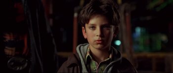 Movie still from “3000 Miles to Graceland” (2001), directed by Demian Lichtenstein – A young boy is looking into the camera; Close Up shot, Over the shoulder angle