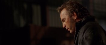 Movie still from “3000 Miles to Graceland” (2001), directed by Demian Lichtenstein – A person looking down at his face; Close Up shot, Over the shoulder angle