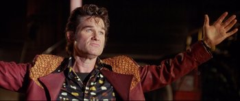 Movie still from “3000 Miles to Graceland” (2001), directed by Demian Lichtenstein – A man in a leather jacket standing in front of a building; Close Up shot, Low angle