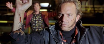 Movie still from “3000 Miles to Graceland” (2001), directed by Demian Lichtenstein – A man in a leather jacket standing next to another man in a leather jacket; Close Up shot, Low angle