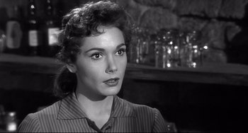 Movie still from “3:10 to Yuma” (1957), directed by Delmer Daves – A black - and - white photo of a woman in a striped shirt; Close Up shot, Over the shoulder angle