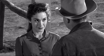 Movie still from “3:10 to Yuma” (1957), directed by Delmer Daves – An old photo of a man and a woman talking to each other; Close Up shot, Over the shoulder angle