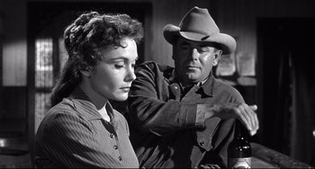Movie still from “3:10 to Yuma” (1957), directed by Delmer Daves – An old photo of a man and a woman; Medium shot, Over the shoulder angle