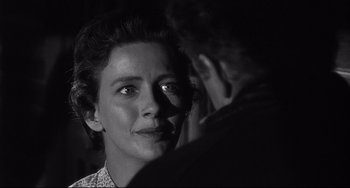 Movie still from “3:10 to Yuma” (1957), directed by Delmer Daves – A black - and - white photo of a woman looking at the camera; Close Up shot, Over the shoulder angle