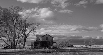 Movie still from “3:10 to Yuma” (1957), directed by Delmer Daves – An old house sitting in the middle of a field; Extreme Wide shot, Low angle