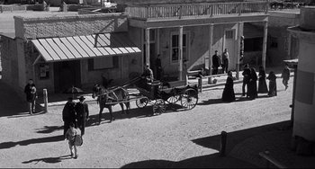 Movie still from “3:10 to Yuma” (1957), directed by Delmer Daves – An old photo of a horse and carriage in a town; Extreme Wide shot, High angle