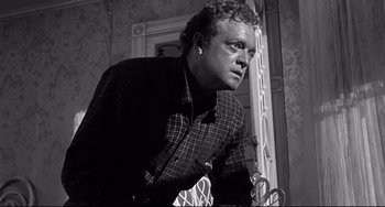 Movie still from “3:10 to Yuma” (1957), directed by Delmer Daves – Black and white photograph of a man looking at the camera; Close Up shot, Low angle