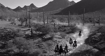 Movie still from “3:10 to Yuma” (1957), directed by Delmer Daves – A black and white photo of people riding horses in the desert; Extreme Wide shot, High angle