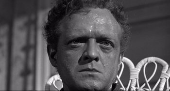 Movie still from “3:10 to Yuma” (1957), directed by Delmer Daves – Black and white photograph of a man's face with water droplets on his face; Close Up shot, Low angle