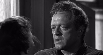 Movie still from “3:10 to Yuma” (1957), directed by Delmer Daves – A black and white photo of a man and a woman; Close Up shot, Over the shoulder angle