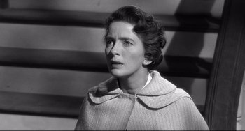 Movie still from “3:10 to Yuma” (1957), directed by Delmer Daves – An old black and white photo of a woman looking at the camera; Close Up shot, High angle