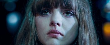 Movie still from “4.3.2.1.” (2010), directed by Mark Davis – A woman's face with green eyes; Close Up shot, Overhead angle