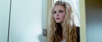Movie still from “4.3.2.1.” (2010), directed by Mark Davis – A woman with long blonde hair looking into a mirror; Close Up shot, Low angle