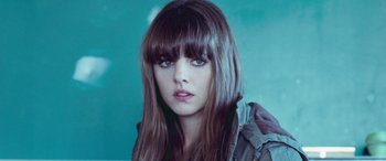 Movie still from “4.3.2.1.” (2010), directed by Mark Davis – A person with long brown hair; Close Up shot, Over the shoulder angle